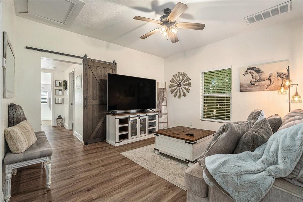 4921 6th Street Zephyrhills, FL 33542 - Photo 6 of 15 a living room with furniture and a flat screen tv