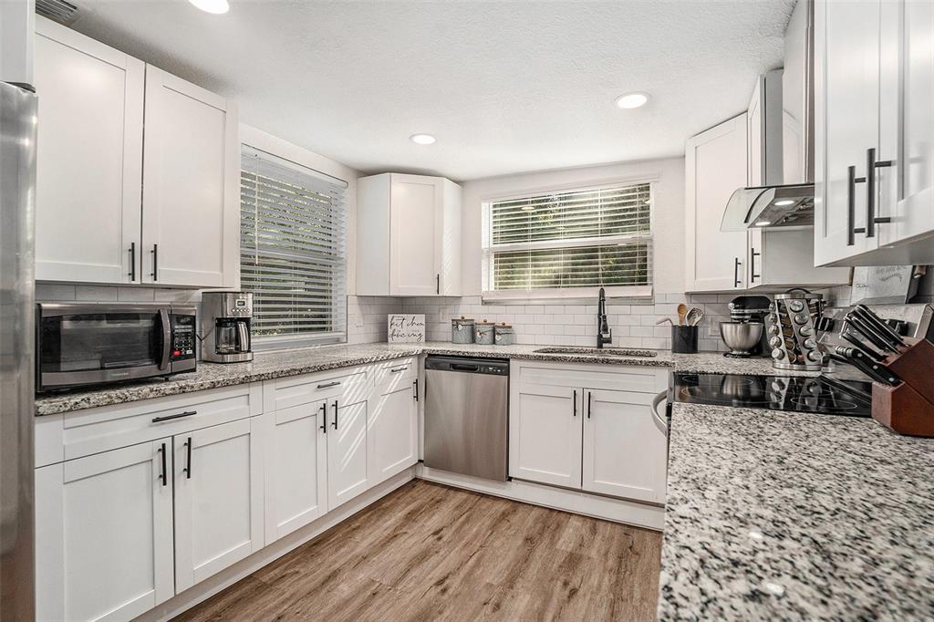 4921 6th Street Zephyrhills, FL 33542 - Photo 8 of 15 a kitchen with sink cabinets and window