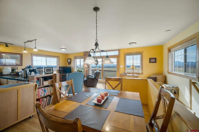 a view of a dining room with furniture window and wooden floor