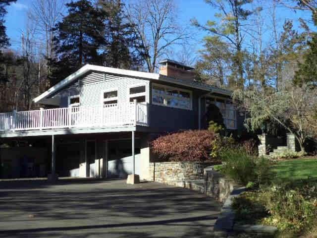 a front view of house with a garden