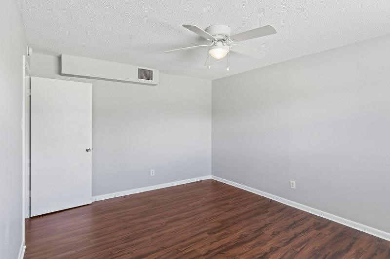 932 7th Avenue North, Unit 6 Texas City, TX 77590 - Photo 5 of 8 a view of an empty room with wooden floor