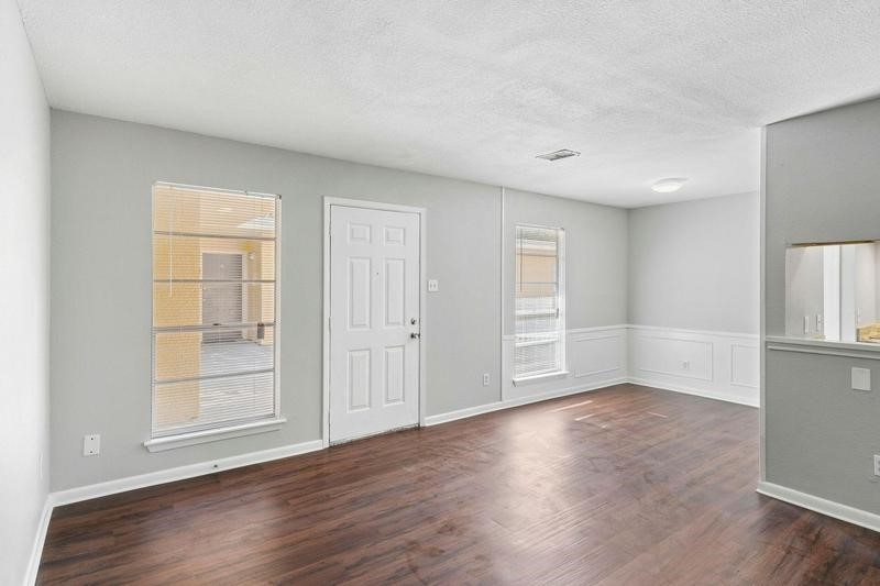 932 7th Avenue North, Unit 6 Texas City, TX 77590 - Photo 6 of 8 an empty room with wooden floor and windows