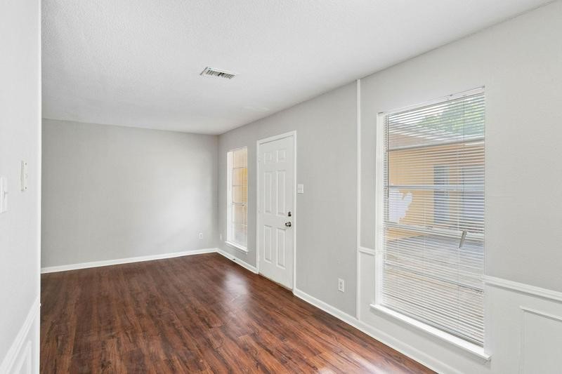 932 7th Avenue North, Unit 6 Texas City, TX 77590 - Photo 7 of 8 a view of an empty room with wooden floor and a window