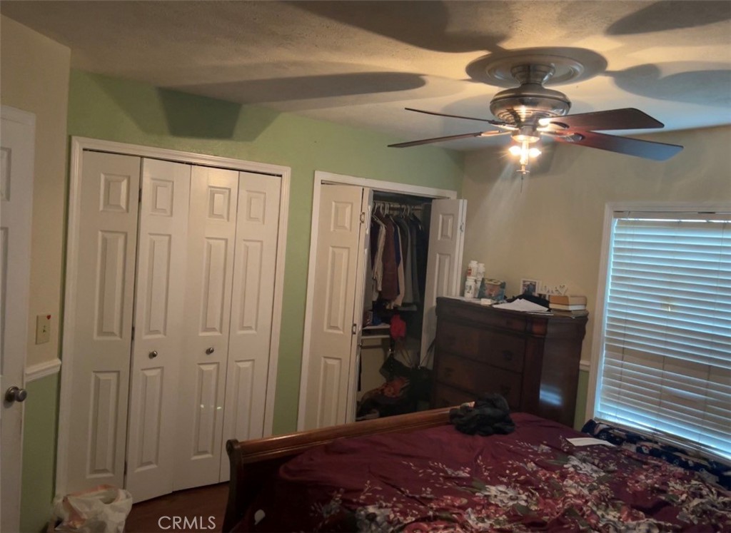 904 Riverside Avenue Chowchilla, CA 93610 - Photo 5 of 6 a bedroom with a bed and a chandelier