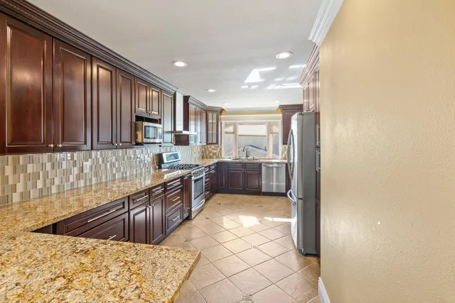 a kitchen with a stove a sink and a refrigerator