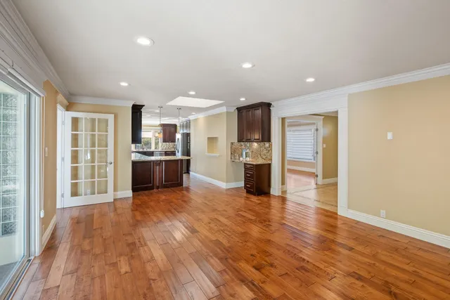 a view of a kitchen with wooden floor and a kitchen