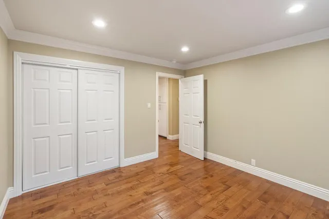 a bathroom with a granite countertop sink a toilet and a mirror