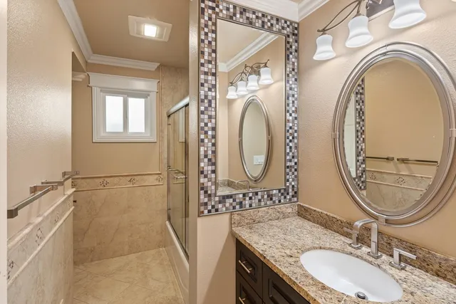 a kitchen with a refrigerator and a stove top oven