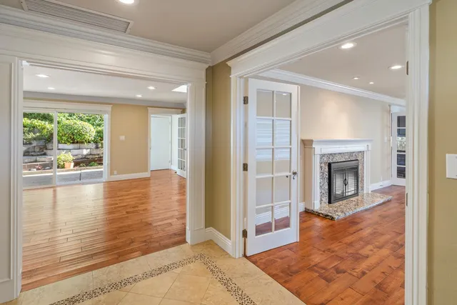 a view of a livingroom with wooden floor and a fireplace