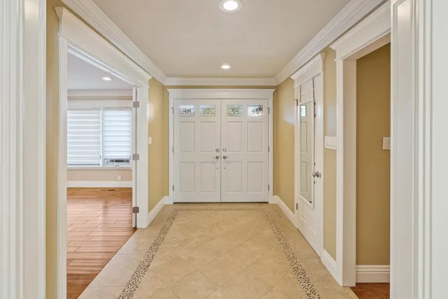 a view of a hallway with an entryway door