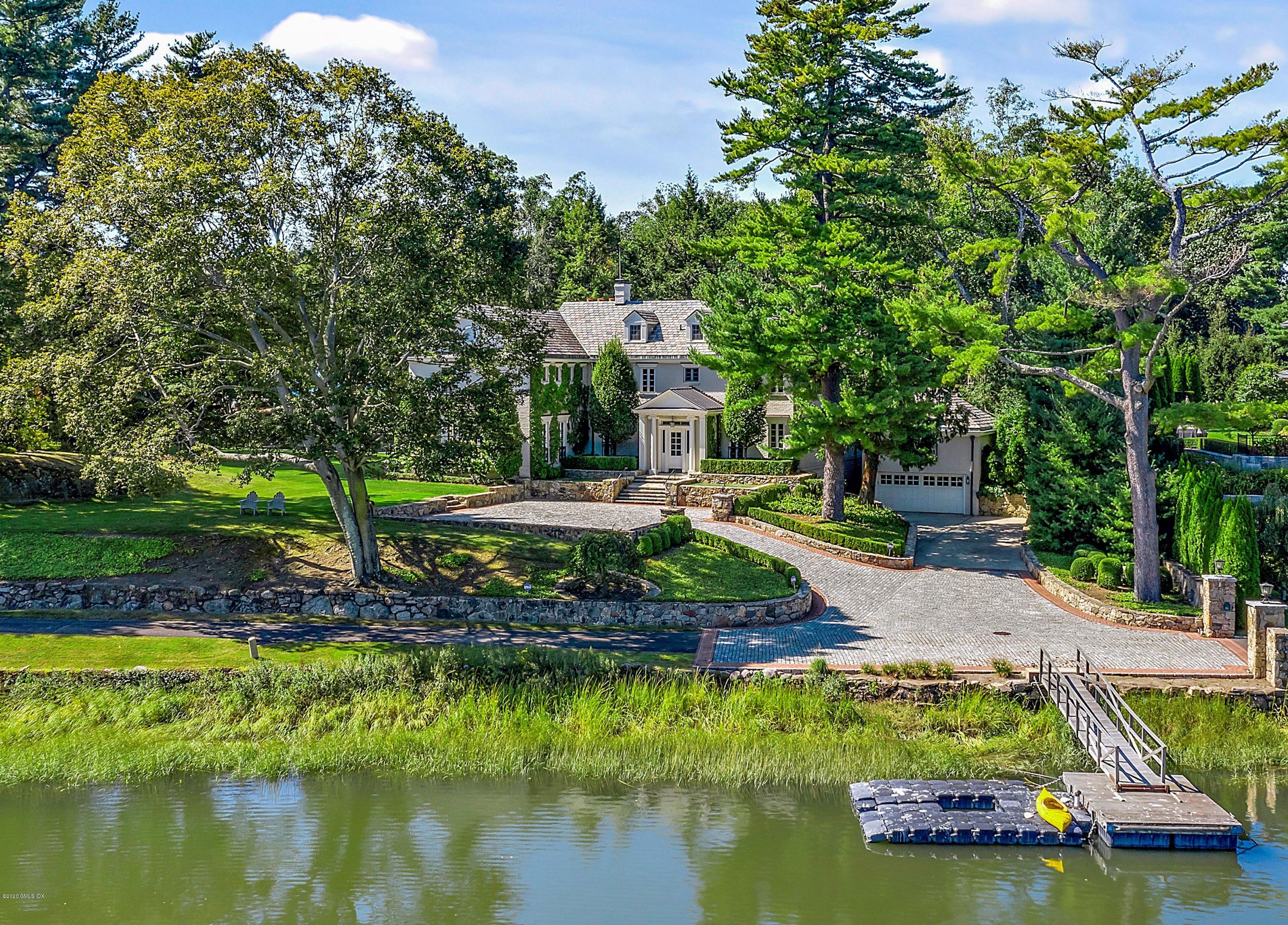 a view of a house with a yard and a large pool