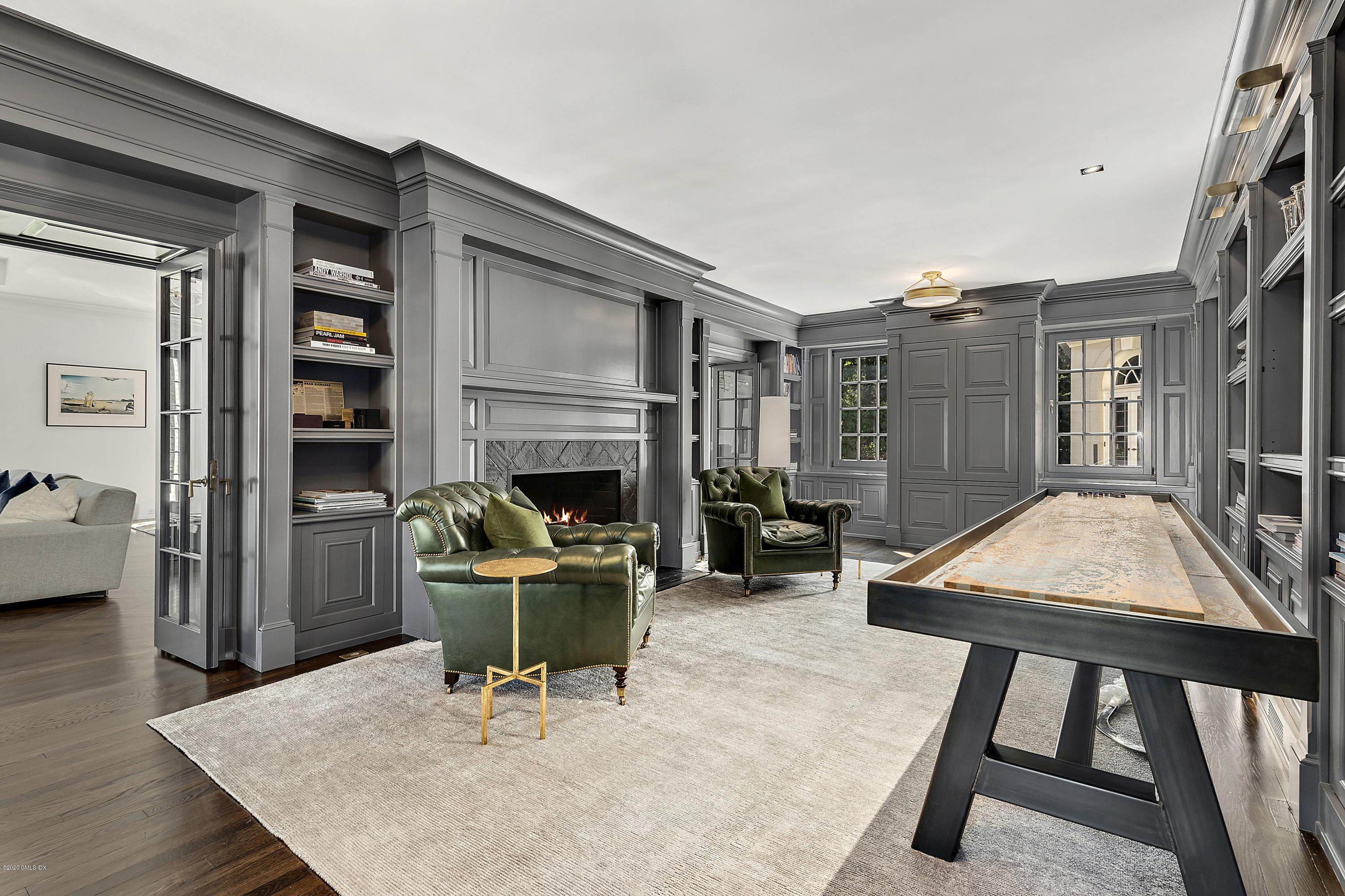 16 Chimney Corner Lane Greenwich, CT 06830 - Photo 16 of 39 a living room with furniture a fireplace and a table