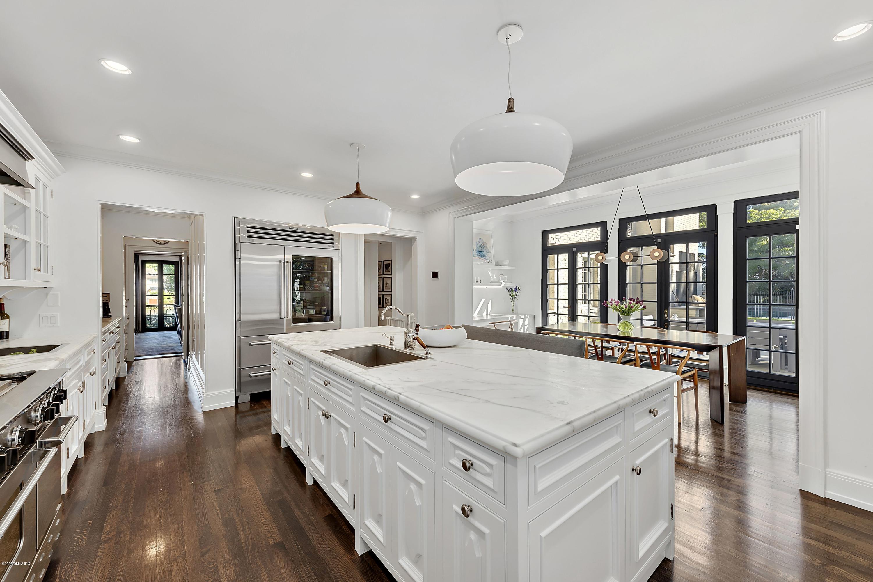 16 Chimney Corner Lane Greenwich, CT 06830 - Photo 17 of 39 a large white kitchen with sink stove and cabinets
