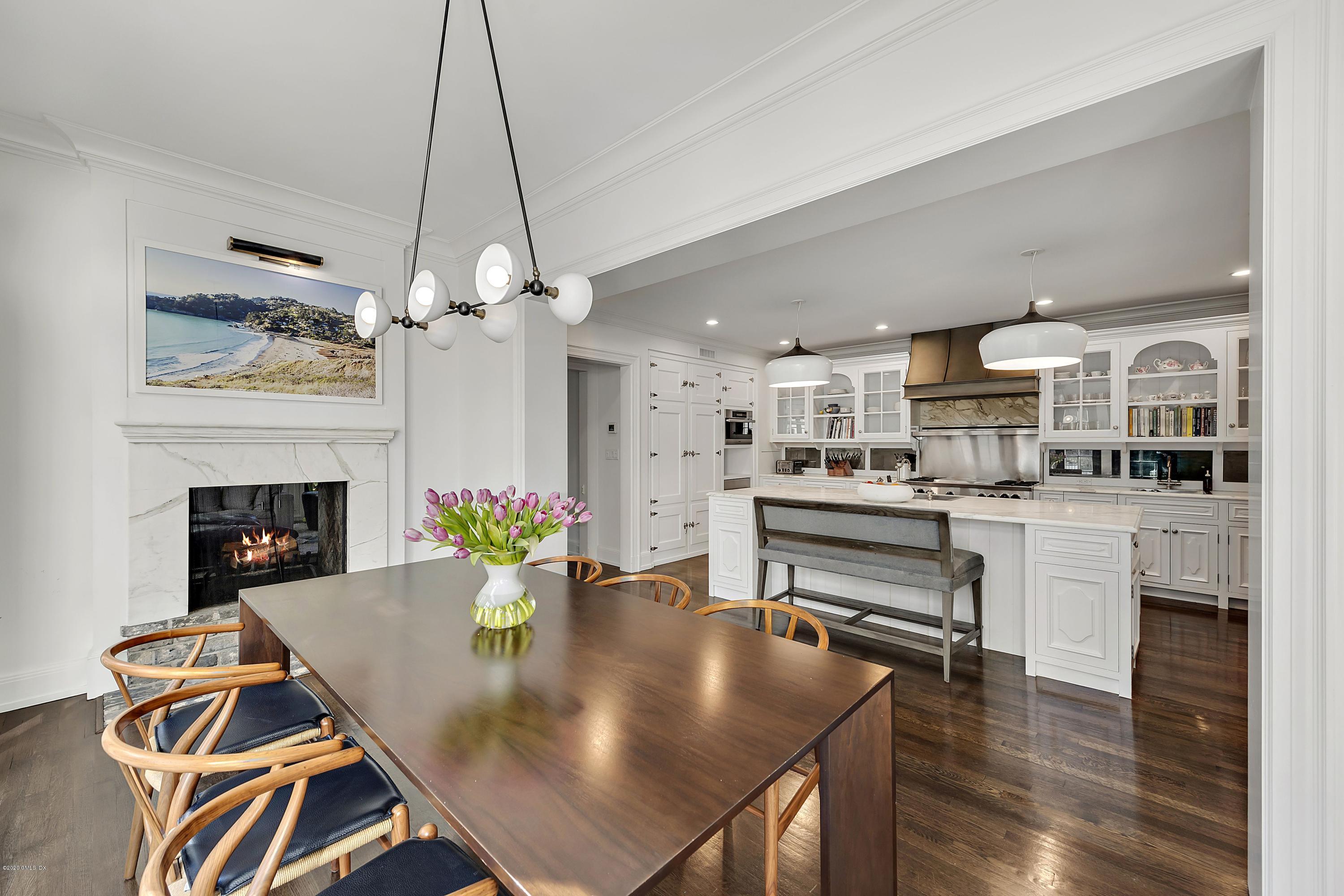 16 Chimney Corner Lane Greenwich, CT 06830 - Photo 19 of 39 a kitchen with a table chairs and white cabinets