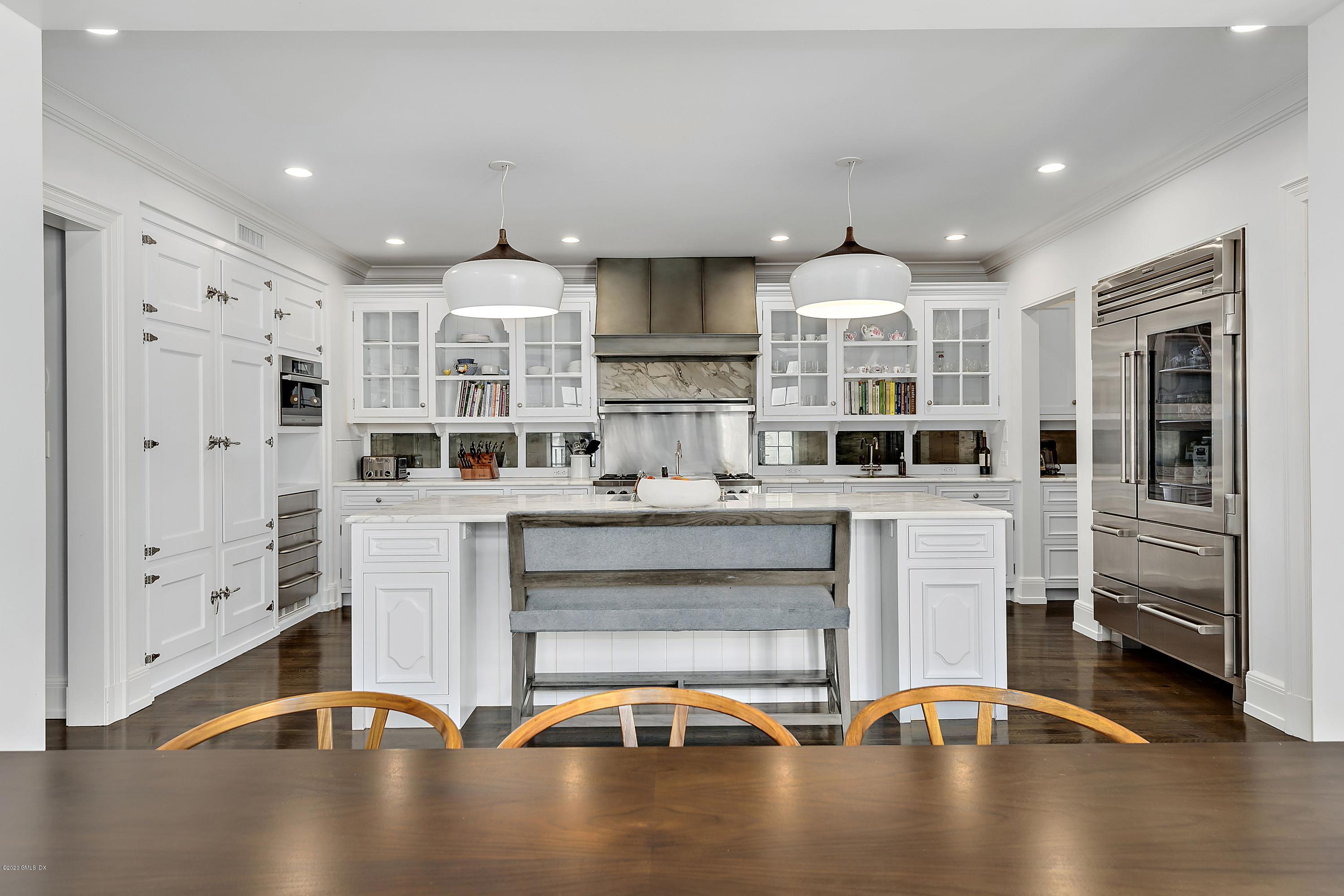 16 Chimney Corner Lane Greenwich, CT 06830 - Photo 20 of 39 a room with stainless steel appliances kitchen island granite countertop a stove a refrigerator a sink a oven with white cabinets and wooden floor