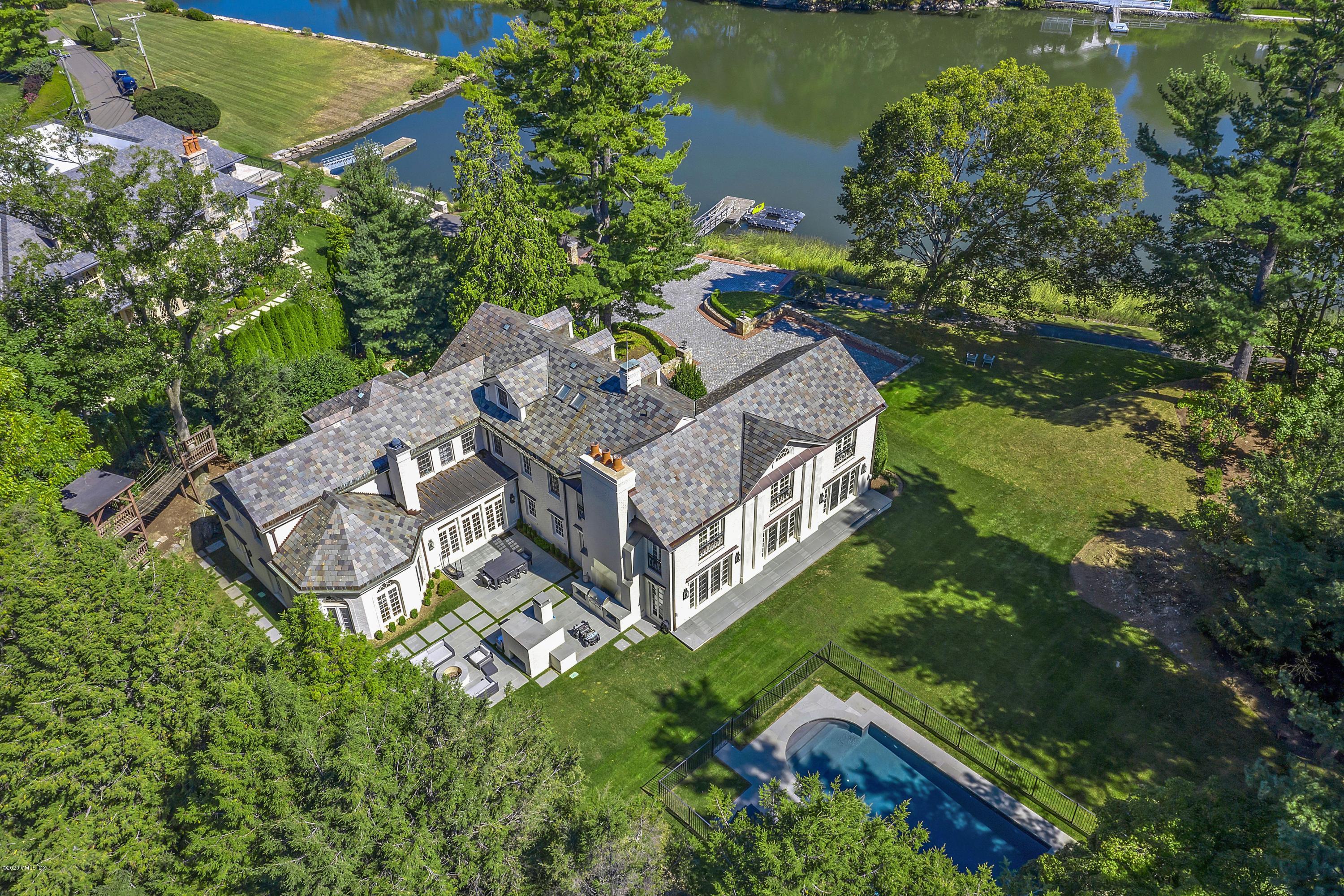 16 Chimney Corner Lane Greenwich, CT 06830 - Photo 2 of 39 an aerial view of a house with a garden and lake view