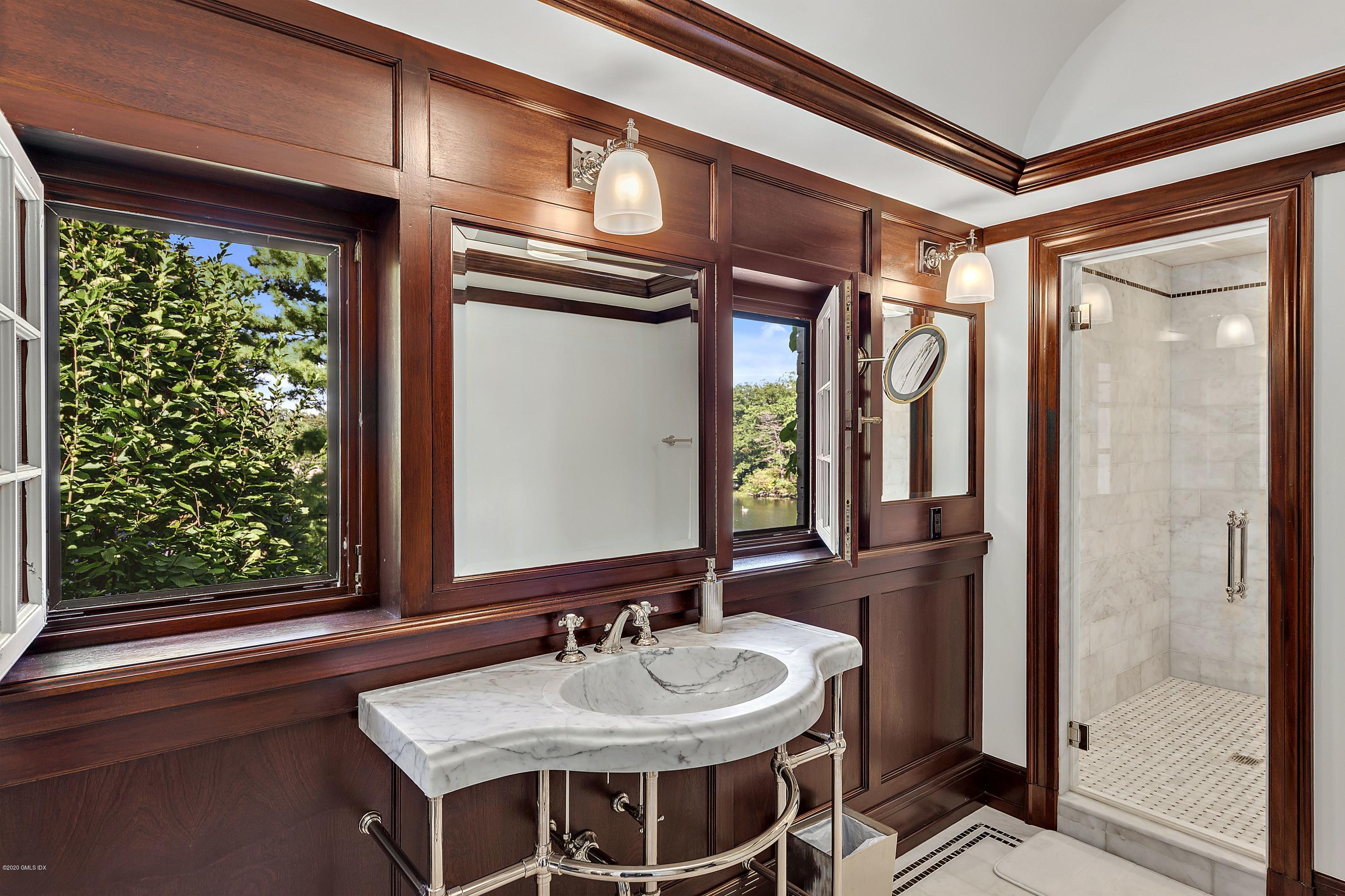 16 Chimney Corner Lane Greenwich, CT 06830 - Photo 27 of 39 a en suite bathroom with a sink a mirror and a shower