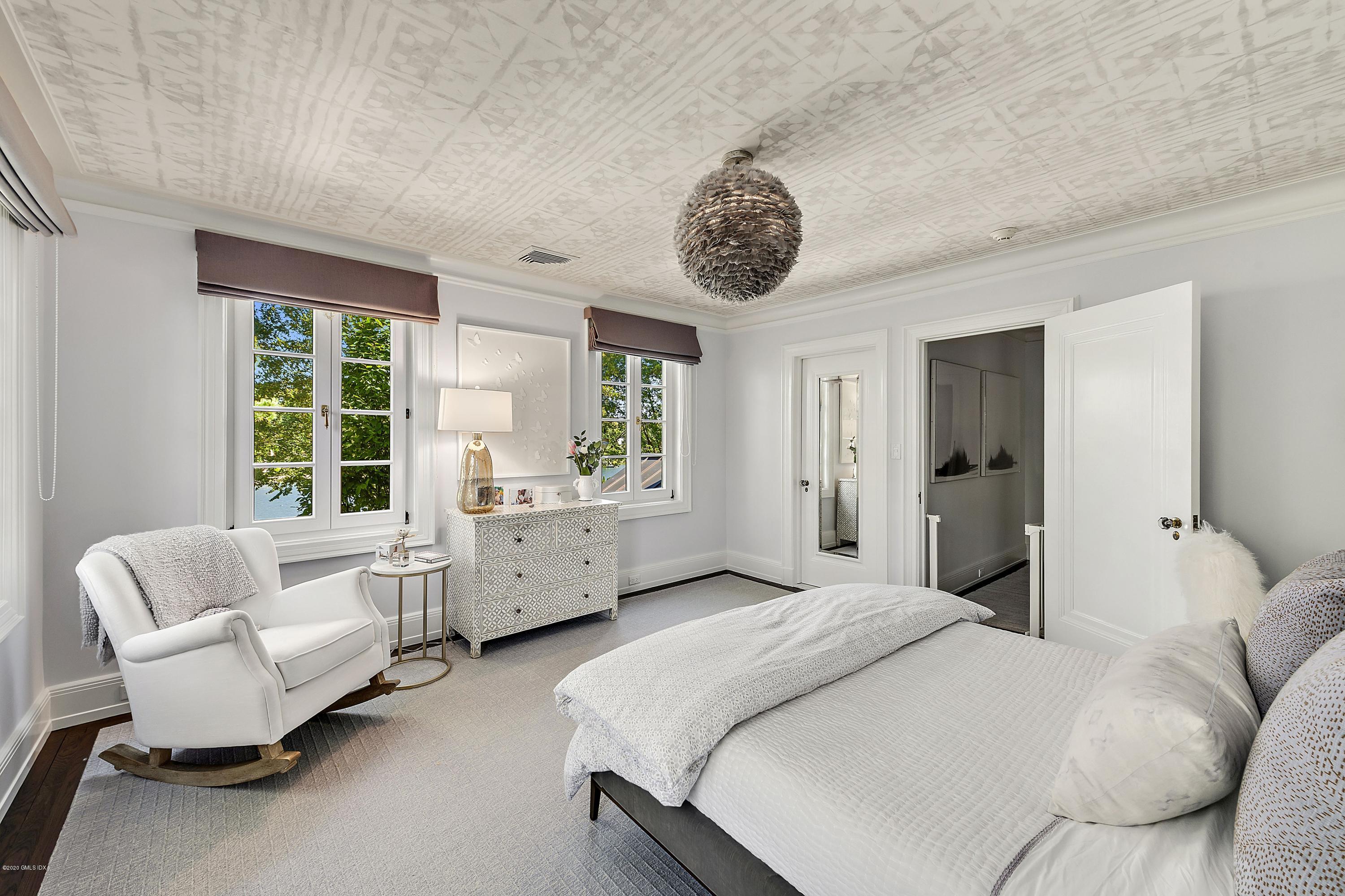 16 Chimney Corner Lane Greenwich, CT 06830 - Photo 29 of 39 a spacious bedroom with a bed and a large window