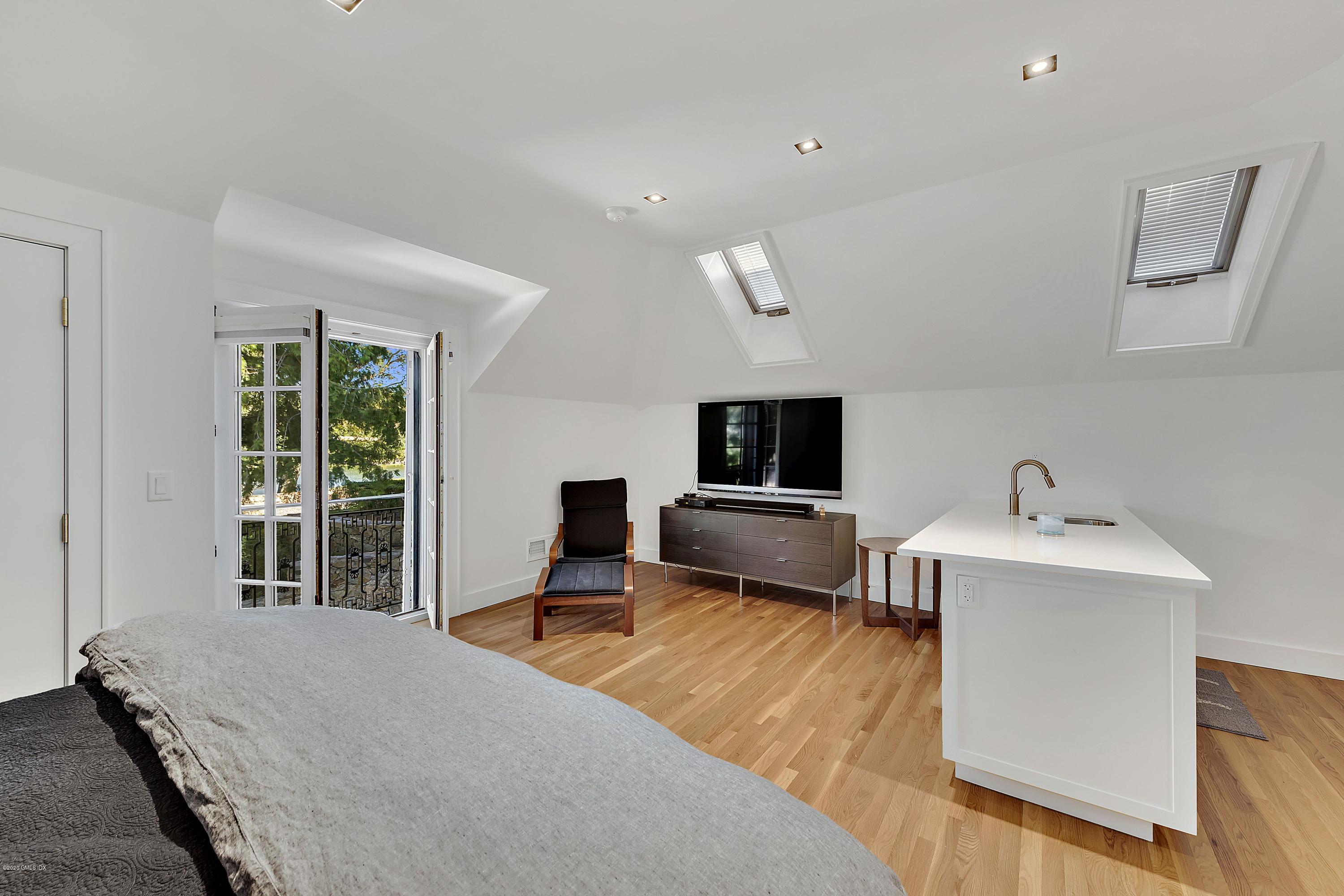 16 Chimney Corner Lane Greenwich, CT 06830 - Photo 33 of 39 a bedroom with a bed and a tv on the table