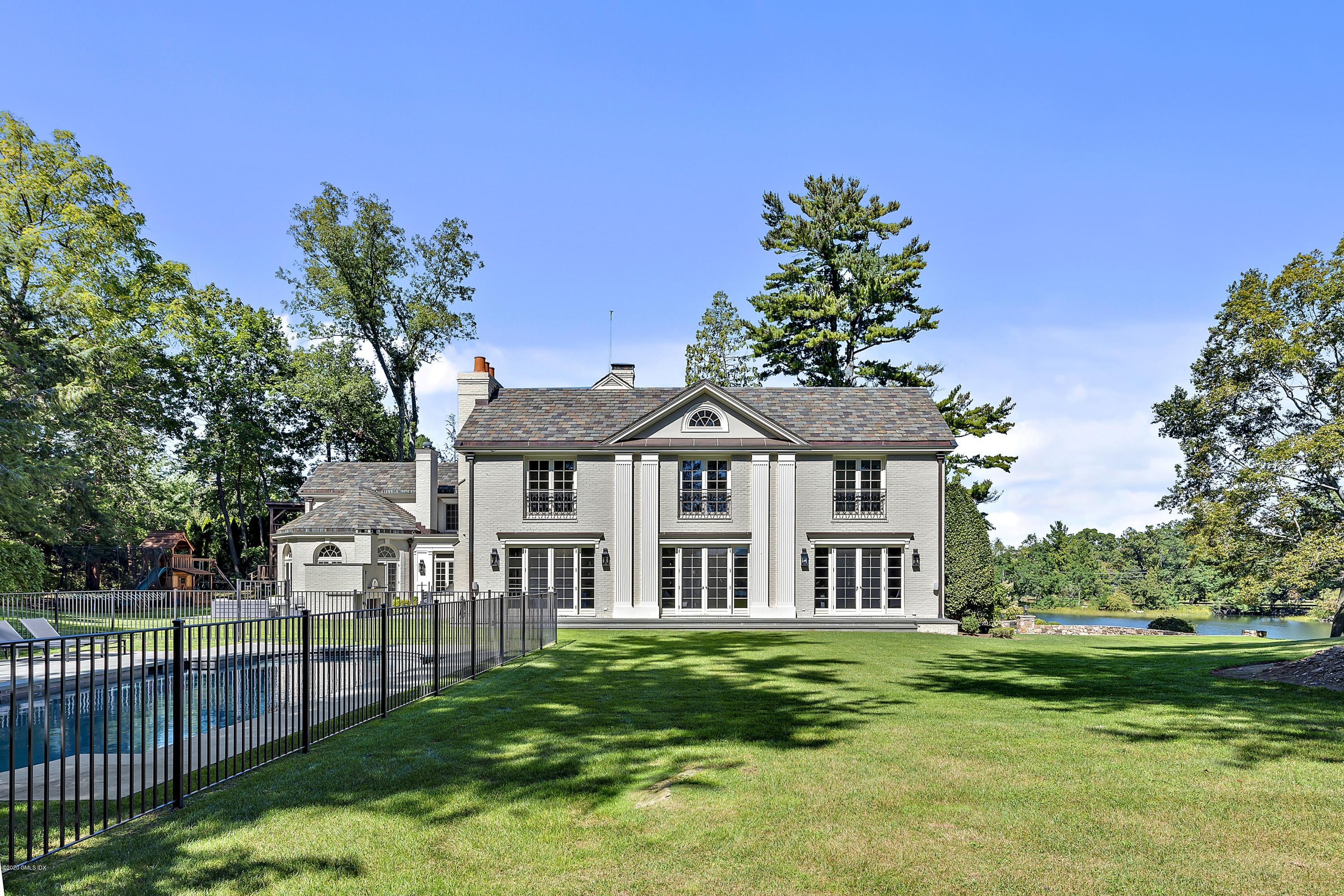 16 Chimney Corner Lane Greenwich, CT 06830 - Photo 35 of 39 a front view of a house with a garden