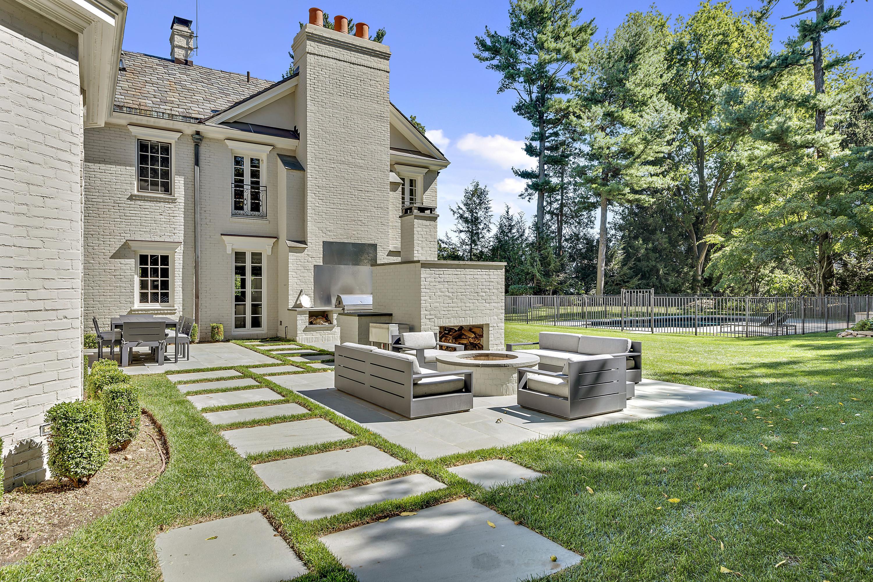 16 Chimney Corner Lane Greenwich, CT 06830 - Photo 36 of 39 a view of a house with a backyard and a patio