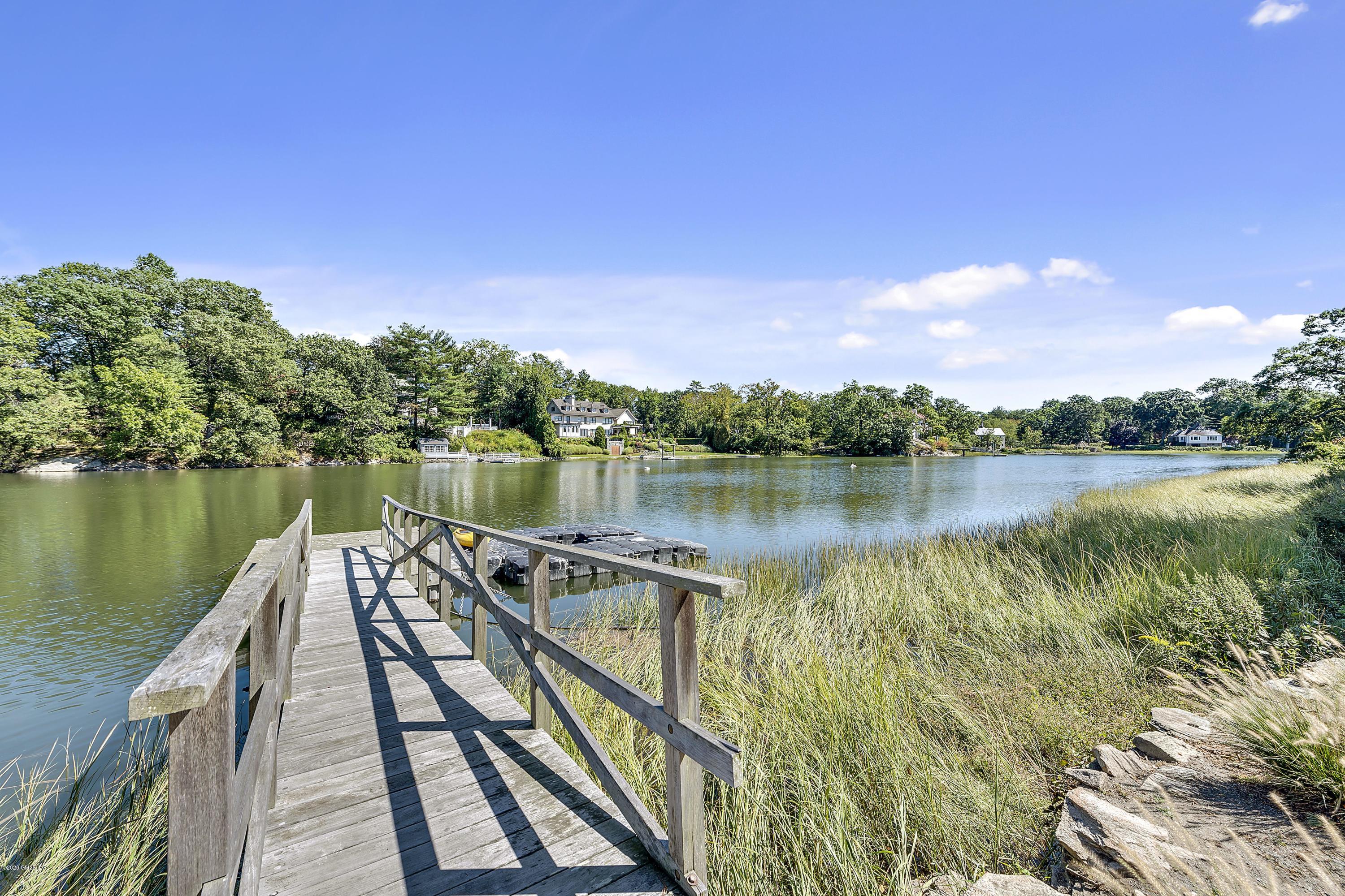 16 Chimney Corner Lane Greenwich, CT 06830 - Photo 39 of 39 a view of a lake with a wooden bridge