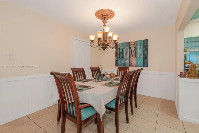 a dining room with furniture and chandelier
