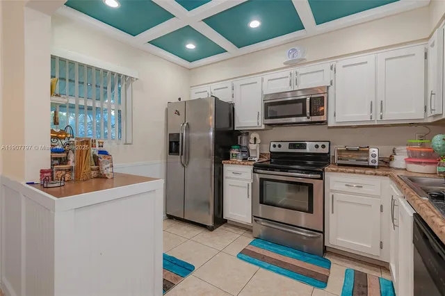 a kitchen with stainless steel appliances a stove a sink and a refrigerator