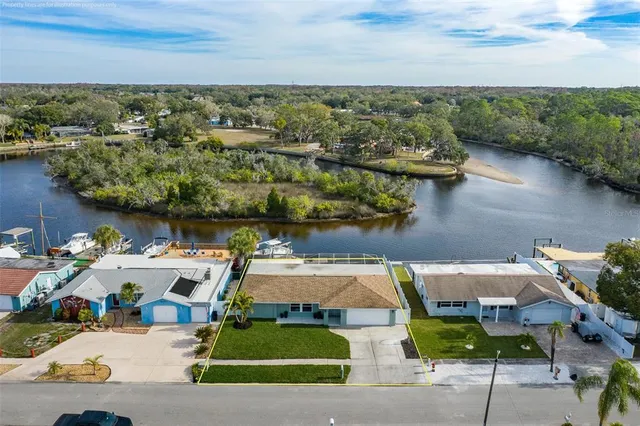 an aerial view of a house with garden space and ocean view