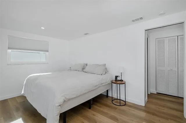 a bedroom with a bed and a large window