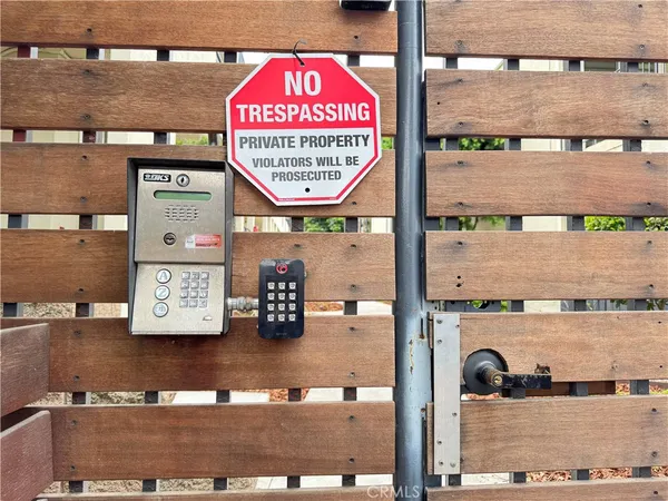 a view of a street with wooden fence