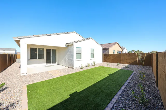 a view of an house with backyard space and balcony