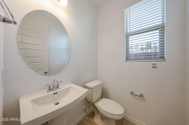 a bathroom with a sink a mirror and a toilet