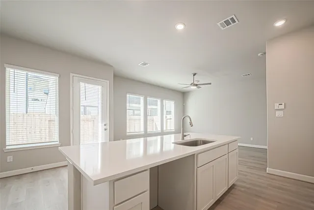 a large white kitchen with a large window