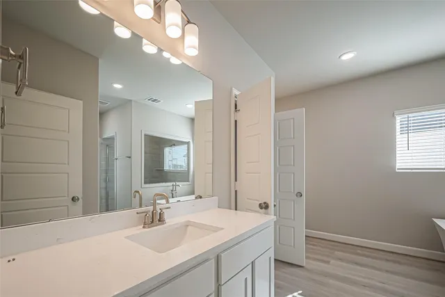 a bathroom with a sink a vanity and a mirror