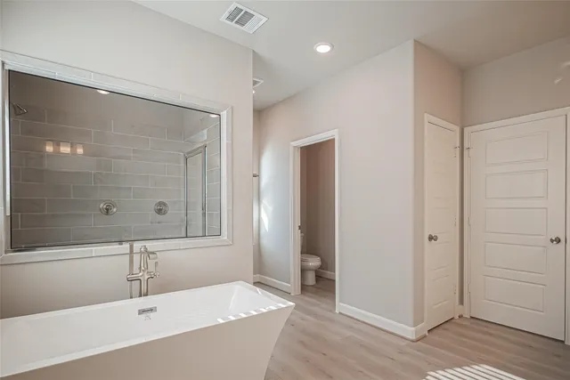 a bathroom with a bathtub and a shower