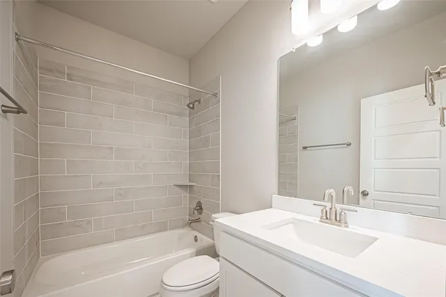 a bathroom with a bathtub shower sink vanity mirror and toilet