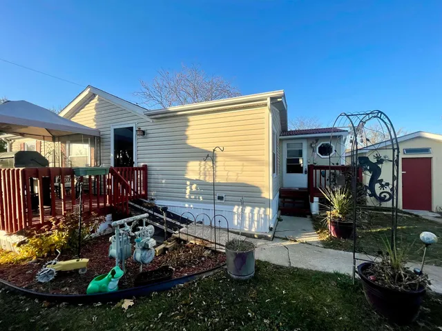 a view of a house with yard and sitting area