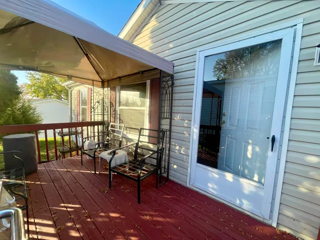 a balcony with furniture and wooden floor