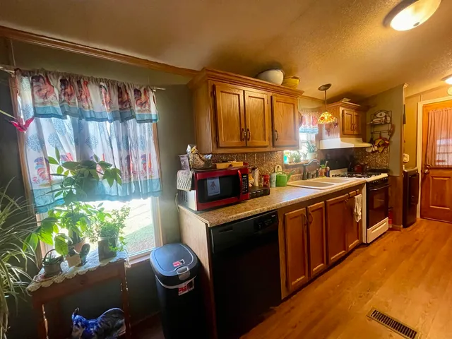 a kitchen with lots of counter space and wooden floor