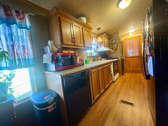 a view of a dining room with furniture and chandelier