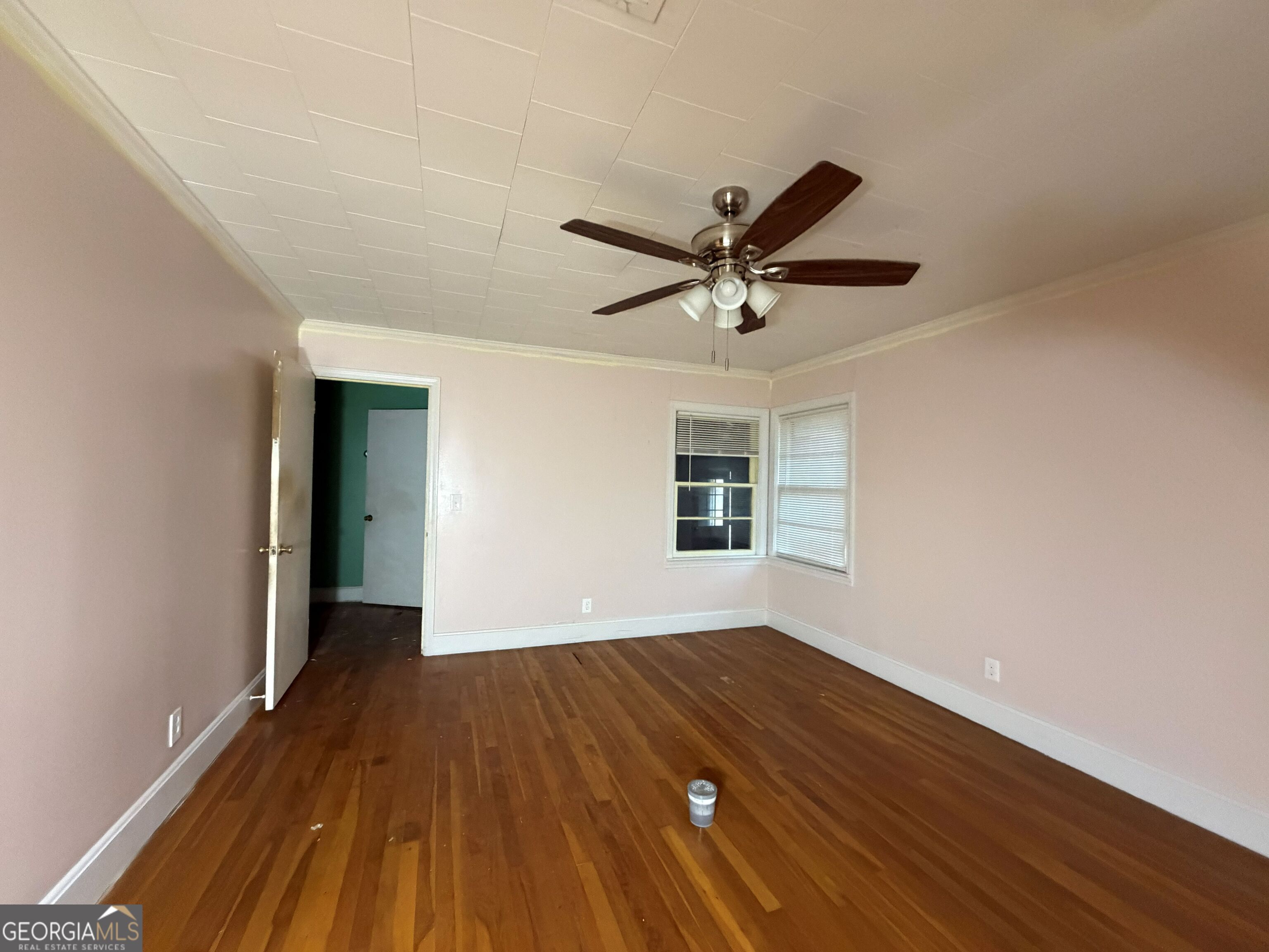 251 Dewey McGlamry Road Fitzgerald, GA 31750 - Photo 4 of 13 an empty room with wooden floor and windows