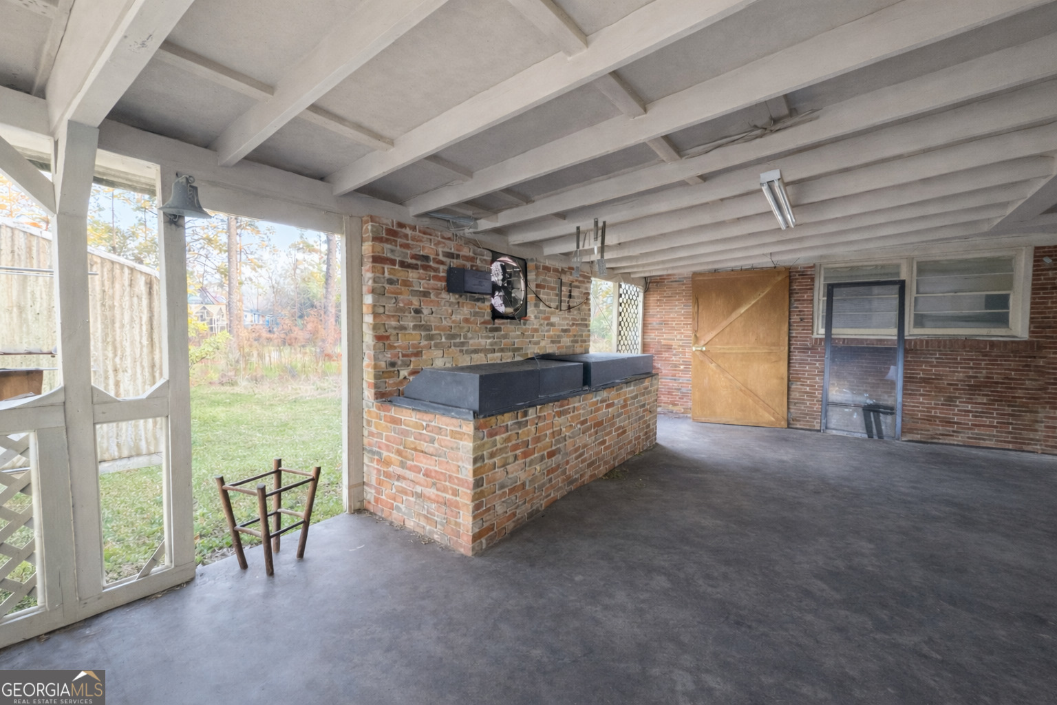 251 Dewey McGlamry Road Fitzgerald, GA 31750 - Photo 7 of 13 a bed room with a bed and a large window