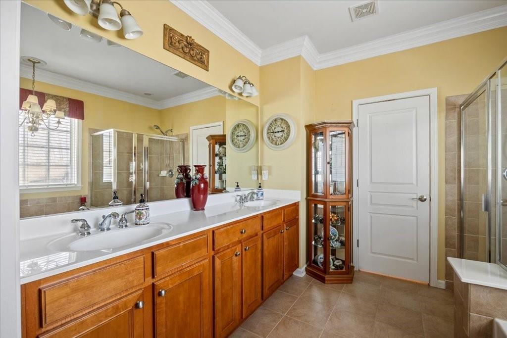 5015 Kings Common Way Cumming, GA 30040 - Photo 12 of 22 a spacious bathroom with a double vanity sink and a mirror
