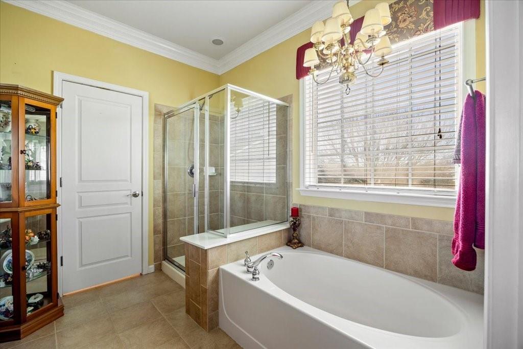 5015 Kings Common Way Cumming, GA 30040 - Photo 13 of 22 a bathroom with a bathtub and shower