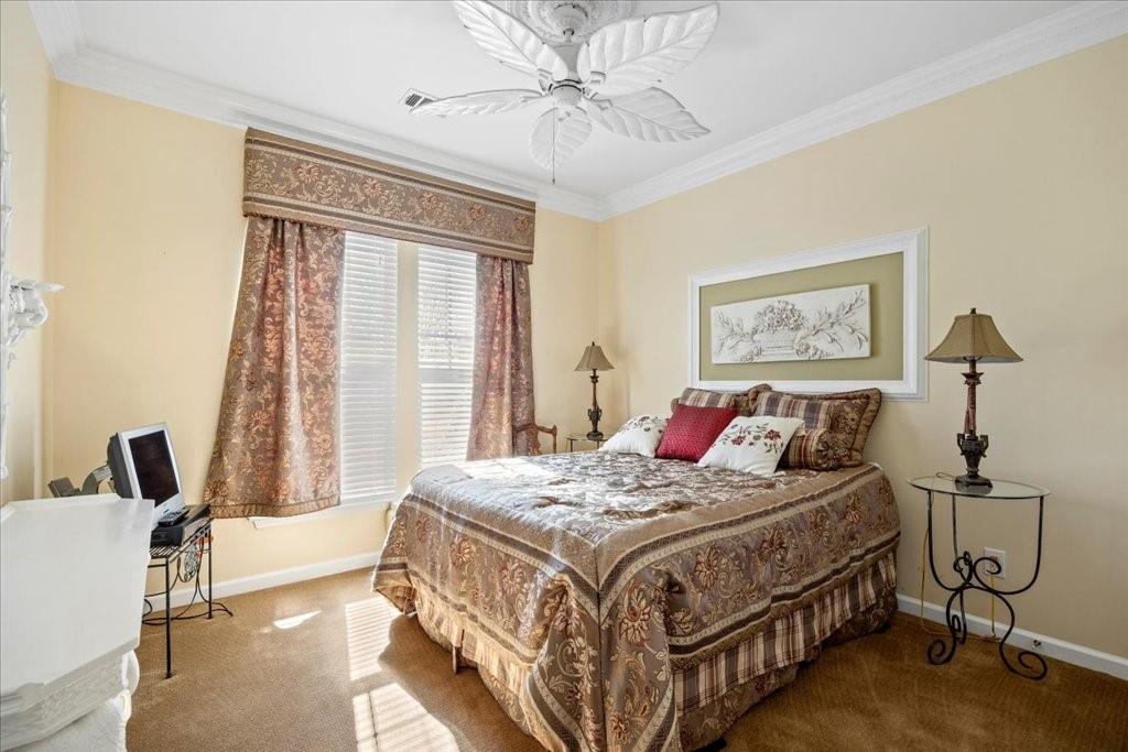 5015 Kings Common Way Cumming, GA 30040 - Photo 16 of 22 a bedroom with a bed a table and chair