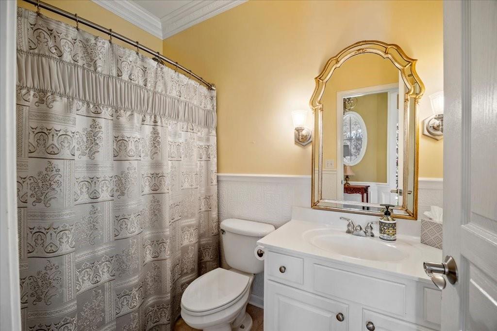 5015 Kings Common Way Cumming, GA 30040 - Photo 17 of 22 a bathroom with a sink a toilet and a mirror