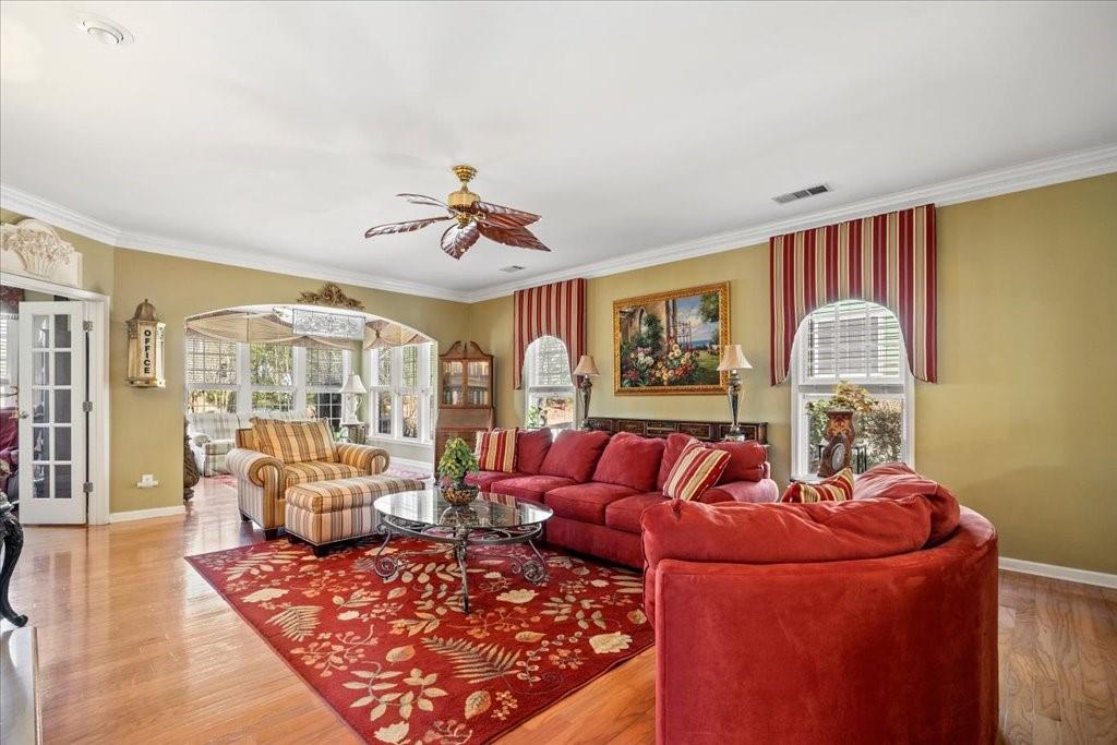 5015 Kings Common Way Cumming, GA 30040 - Photo 4 of 22 a living room with furniture a table and a chandelier