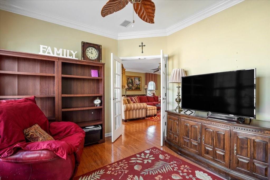 5015 Kings Common Way Cumming, GA 30040 - Photo 9 of 22 a living room with furniture and a flat screen tv