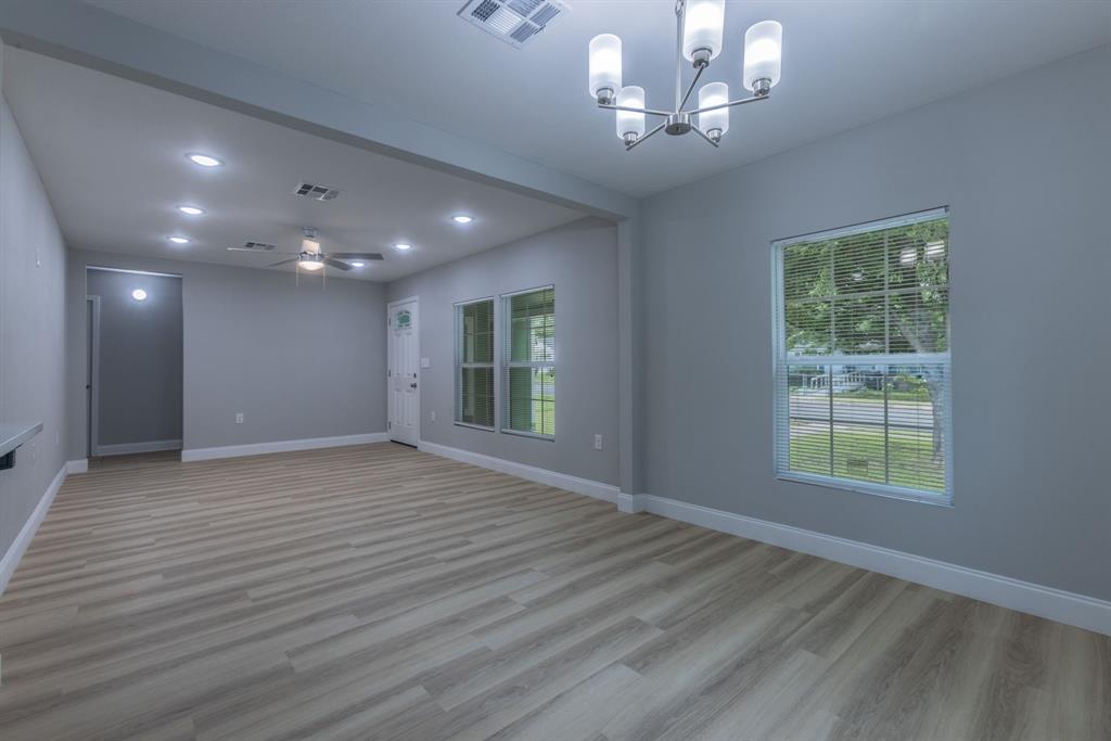 2816 Summer Avenue Waco, TX 76708 - Photo 4 of 16 a view of an empty room with wooden floor and a window